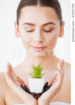 Skin Care. Beauty Woman Face With Healthy Skin And Green Plant Skin Care. Beauty Woman Face With Healthy Skin And Green Plant 65892166