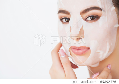 Spa Woman applying Facial cleansing Mask. Beauty Treatments 65892176