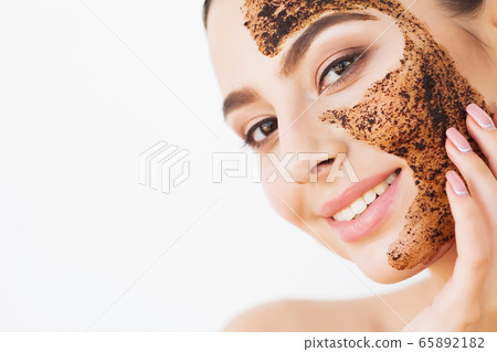 Spa Woman applying Facial cleansing Mask. Beauty Treatments 65892182