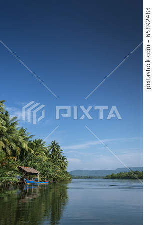 boat and jungle hut on the tatai river in cambodia boat and jungle hut on the tatai river in cambodia 65892483