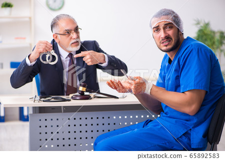 Male doctor in courthouse meeting with advocate 65892583