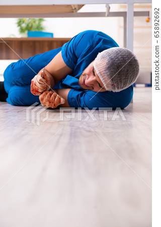 Young male doctor surgeon in fatal negligence concept 65892692