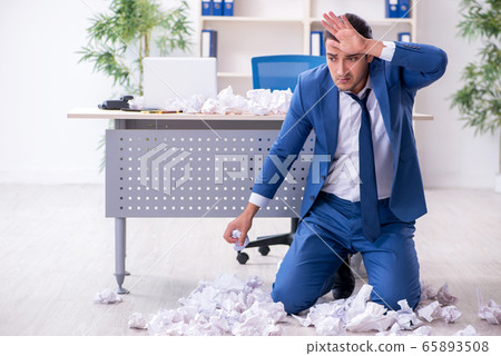 Businessman rejecting new ideas with lots of papers Businessman rejecting new ideas with lots of papers 65893508