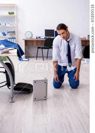 Young male employee unhappy with his work Young male employee unhappy with his work 65893516