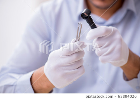Young male jeweler at workshop Young male jeweler at workshop 65894026