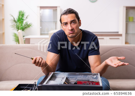 Young man repairing computer at home Young man repairing computer at home 65894636