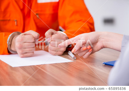 Young man meeting with advocate in pre-trial detention 65895836
