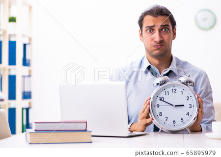 Young male employee working from house 65895979