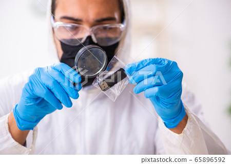 Male expert criminologist working in the lab for evidence Male expert criminologist working in the lab for evidence 65896592