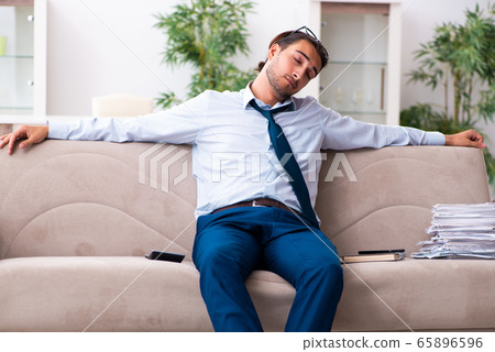 Young male businessman working at home Young male businessman working at home 65896596