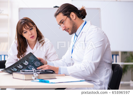 Young male doctor radiologist and female student in the classroo 65896597