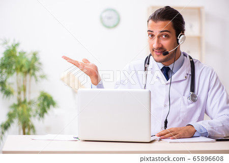Young doctor listening to patient during telemedicine session 65896608