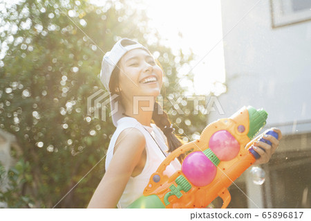 Lively woman in Songkran day. Lively woman in Songkran day. 65896817
