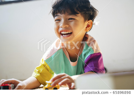 Little boy giggle while playing. Little boy giggle while playing. 65896898
