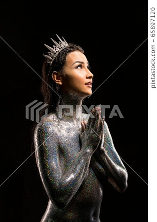 topless brunette with glitter bodyart and crown 65897120