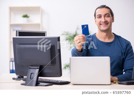 Young male it specialist working in the office Young male it specialist working in the office 65897760