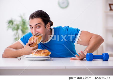 Young hungry man in dieting concept 65898743