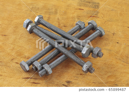 Screw and bolt nut working item on the wood table Screw and bolt nut working item on the wood table 65899487