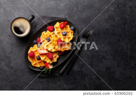 Delicious belgian waffles with summer berries Delicious belgian waffles with summer berries 65900202