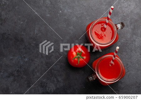 Fresh tomato juice and ripe tomatoes Fresh tomato juice and ripe tomatoes 65900207