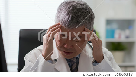 Senior asian doctor feel tired 65900318