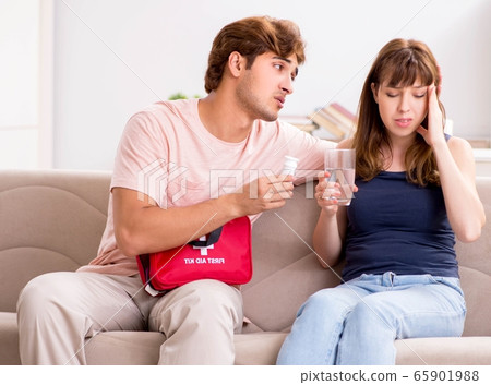 Young family getting treatment with first aid kit 65901988