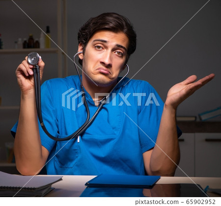 Young handsome doctor working night shift in hospital Young handsome doctor working night shift in hospital 65902952