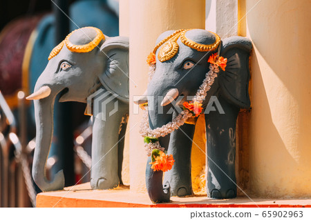 Mapusa, Goa, India. Elephant Statue Near The Shree Ganesh Mandir, Ganeshpuri Temple. Famous Landmark And Popular Destination Mapusa, Goa, India. Elephant Statue Near The Shree Ganesh Mandir, Ganeshpuri Temple. Famous Landmark And Popular Destination 65902963