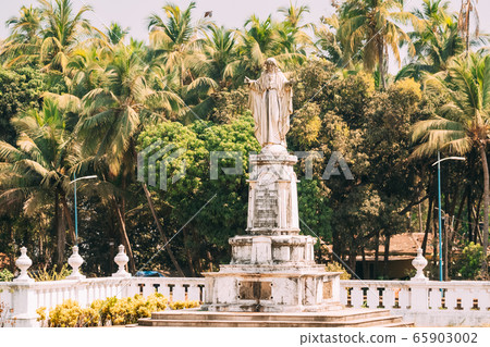 Old Goa, India. Cathedral Of St. Paul And Statue Of Jesus In Sunny Day Old Goa, India. Cathedral Of St. Paul And Statue Of Jesus In Sunny Day 65903002