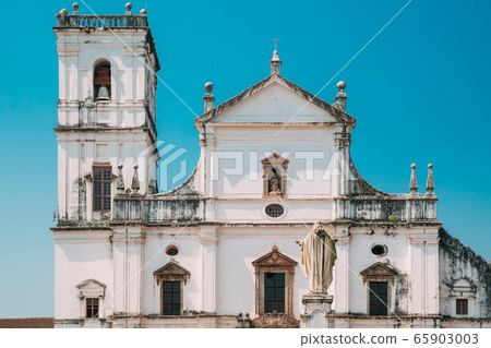 Old Goa, India. Cathedral Of St. Paul And Statue Of Jesus In Sunny Day Old Goa, India. Cathedral Of St. Paul And Statue Of Jesus In Sunny Day 65903003