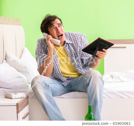 Young man sad in unhappy love concept 65903061