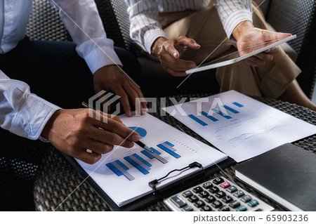 Business team brainstorming and discussing with financial data and report graph. Business team brainstorming and discussing with financial data and report graph. 65903236