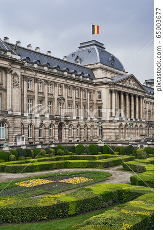 The Royal Palace in Brussels, Belgium from the northeastern corner in spring. National flag of the Kingdom of Belgium waving on top. The Royal Palace in Brussels, Belgium from the northeastern corner in spring. National flag of the Kingdom of Belgium waving on top. 65903677