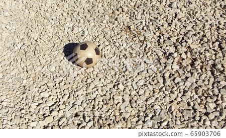 Childrens rubber soccer ball old. Background 65903706