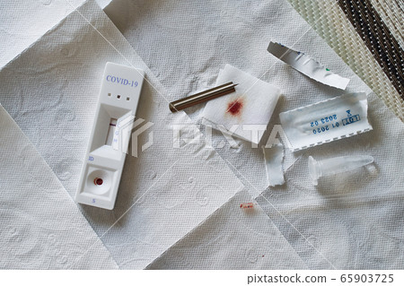 Negative test result by using rapid test device for COVID-19 novel coronavirus on a home kitchen table. Negative test result by using rapid test device for COVID-19 novel coronavirus on a home kitchen table. 65903725