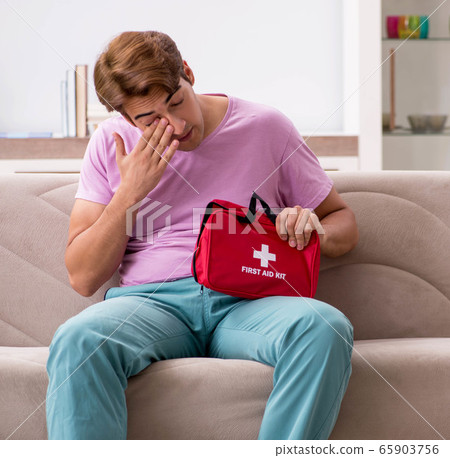 Sick man at home with first aid kit Sick man at home with first aid kit 65903756