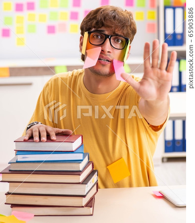 Student preparing for exams with many conflicting priorities 65903886