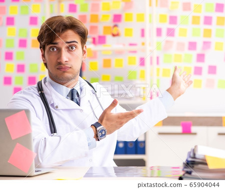 Male doctor with many conflicting prioritites Male doctor with many conflicting prioritites 65904044