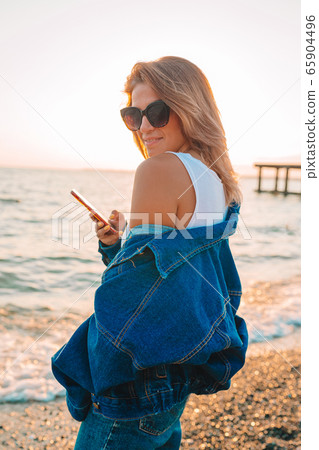 Outdoor fashion portrait of stylish woman on the beach. 65904496