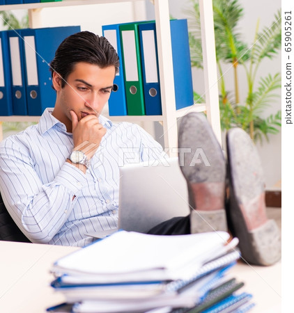 Young employee sitting at the office 65905261