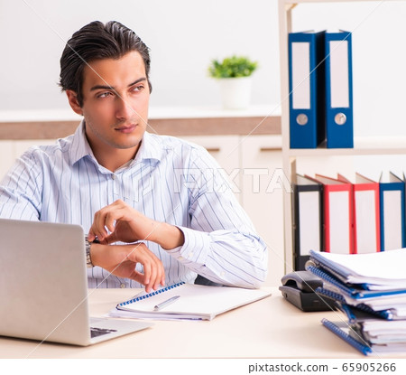Young employee sitting at the office Young employee sitting at the office 65905266