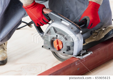 Craftsman working with a hand cutter 65905615