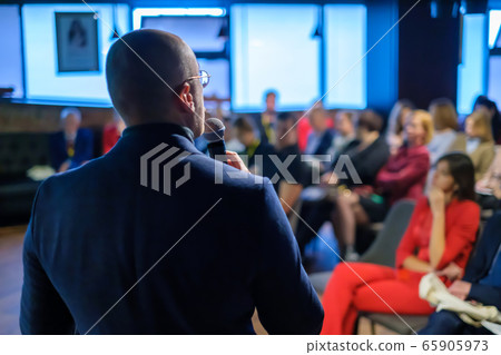 Male presenter speaks to audiences Male presenter speaks to audiences 65905973