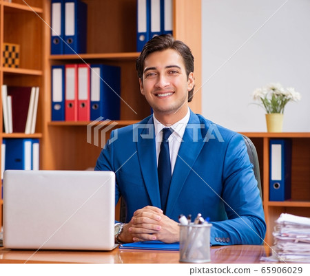Young employee working in the office Young employee working in the office 65906029