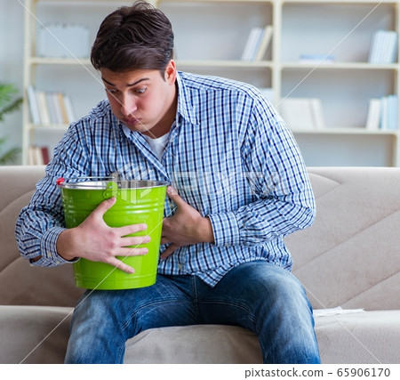 Sick man suffering at home from infection and bad stomach 65906170