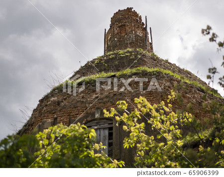 Dome of an ancient red brick temple. Ruins of an Orthodox Church against a blue sky white clouds Dome of an ancient red brick temple. Ruins of an Orthodox Church against a blue sky white clouds 65906399