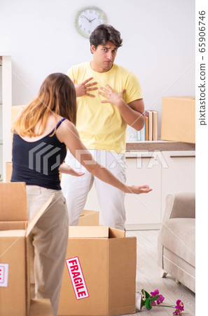 Young couple moving to new flat with fragile things Young couple moving to new flat with fragile things 65906746