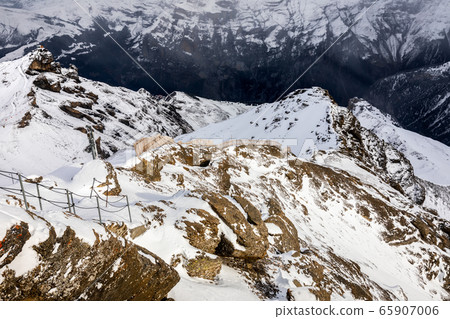 Snow capped mountains in Switzerland in winter. 65907006
