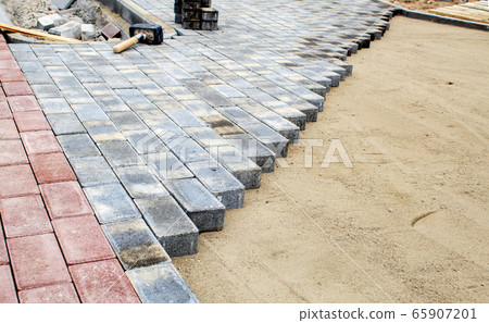construction of a new modern sidewalk made of 65907201