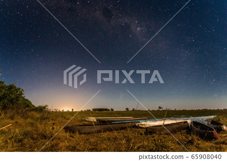 Botswanian local mokoro boats under the starlight 65908040